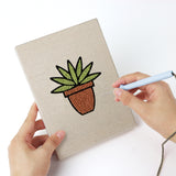 Punching a Brown Pot Blooms mini canvas with the punch needle