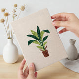 Hand holding a finished Brown Pot Jungle mini canvas