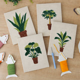 The four finished Brown Pot Jungle mini canvases laid out on a table