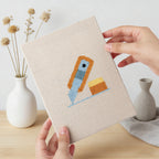 Hand holding a finished Brush Mug Crafts mini canvas