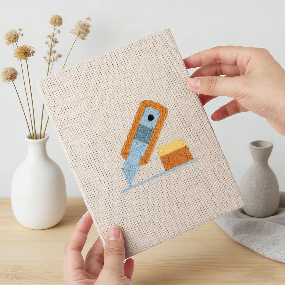 Hand holding a finished Brush Mug Crafts mini canvas