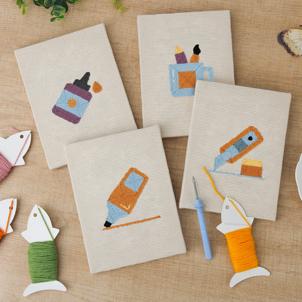 The four finished Brush Mug Crafts mini canvases laid out on a table
