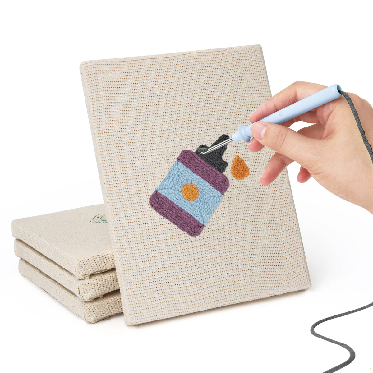 Hand punching one of the Brush Mug Crafts mini canvases