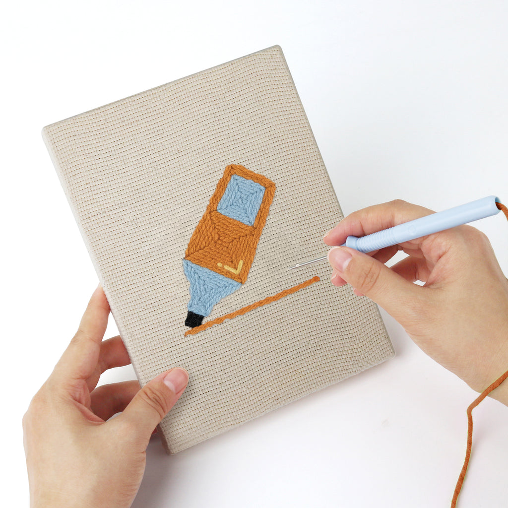 Punching a Brush Mug Crafts mini canvas with the punch needle