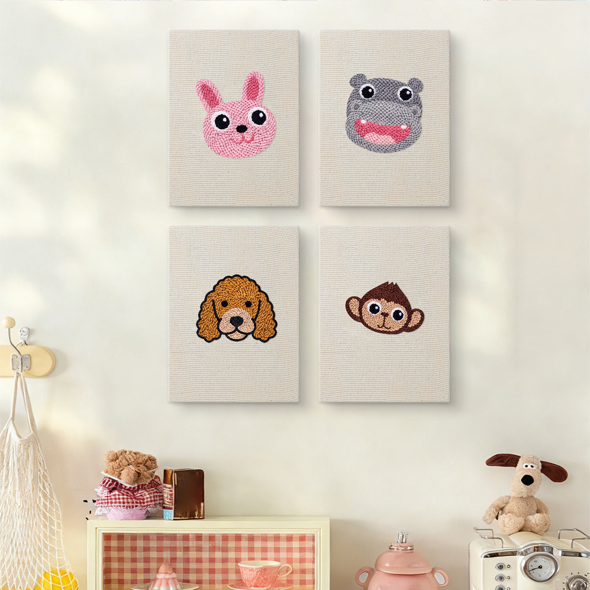 The four Bunny and Hippo mini canvases on a wall above a shelf