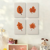 The four Burnt Orange Leaves mini canvases on a wall above a shelf