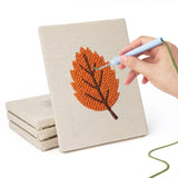 Hand punching one of the Burnt Orange Leaves mini canvases