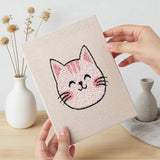 Hand holding a finished Calico Cat Faces mini canvas
