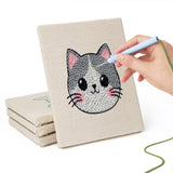 Hand punching one of the Calico Cat Faces mini canvases