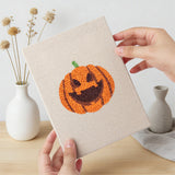 Hand holding a finished Candy and Cauldron mini canvas