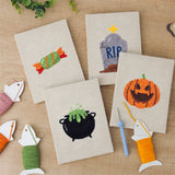 The four finished Candy and Cauldron mini canvases laid out on a table