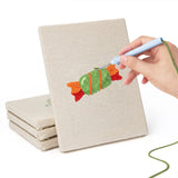 Hand punching one of the Candy and Cauldron mini canvases