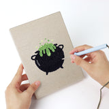 Punching a Candy and Cauldron mini canvas with the punch needle