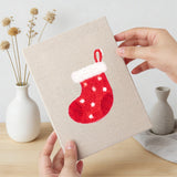 Hand holding a finished Candy Cane Bow mini canvas