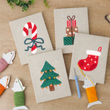 The four finished Candy Cane Bow mini canvases laid out on a table