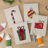 The four finished Candy Cane Gifts mini canvases laid out on a table