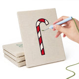Hand punching one of the Candy Cane Gifts mini canvases