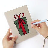 Punching a Candy Cane Gifts mini canvas with the punch needle