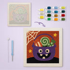 Candy Cauldron canvas before and after punching, with the threads and tools