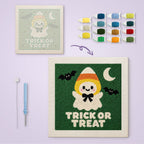 Candy Corn Ghost canvas before and after punching, with the threads and tools