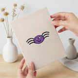 Hand holding a finished Candy Pumpkin Cat mini canvas