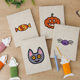 The four finished Candy Pumpkin Cat mini canvases laid out on a table