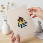Hand holding a finished Caramel Pudding Cafe mini canvas
