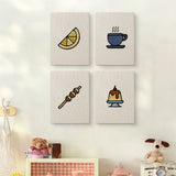 The four Caramel Pudding Cafe mini canvases on a wall above a shelf