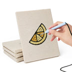 Hand punching one of the Caramel Pudding Cafe mini canvases