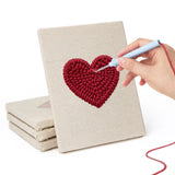 Hand punching one of the Card Suits mini canvases