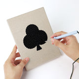 Punching a Card Suits mini canvas with the punch needle