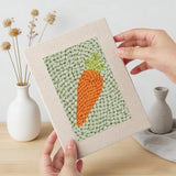 Hand holding a finished Carrot and Eggplant mini canvas