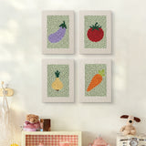 The four Carrot and Eggplant mini canvases on a wall above a shelf