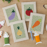 The four finished Carrot and Eggplant mini canvases laid out on a table