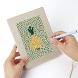 Punching a Carrot and Eggplant mini canvas with the punch needle