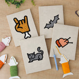The four finished Cat and Bat mini canvases laid out on a table
