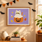 Finished Cat Ghost on a Pumpkin punch needle canvas on a wall