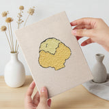 Hand holding a finished Cauliflower Corner mini canvas