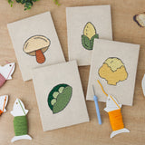 The four finished Cauliflower Corner mini canvases laid out on a table