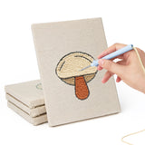 Hand punching one of the Cauliflower Corner mini canvases