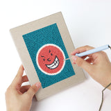Punching a Cheeky Face Circles mini canvas with the punch needle