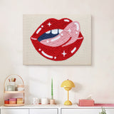 Finished Cheeky Red Lips punch needle canvas on a wall