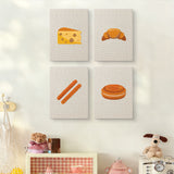 The four Cheese and Pastries mini canvases on a wall above a shelf