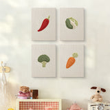 The four Chili and Carrot mini canvases on a wall above a shelf