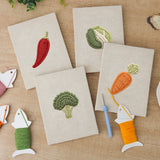 The four finished Chili and Carrot mini canvases laid out on a table
