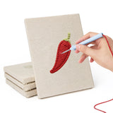 Hand punching one of the Chili and Carrot mini canvases