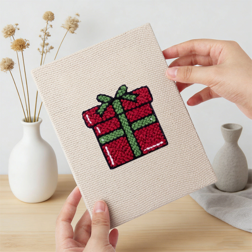 Hand holding a finished Christmas Morning mini canvas