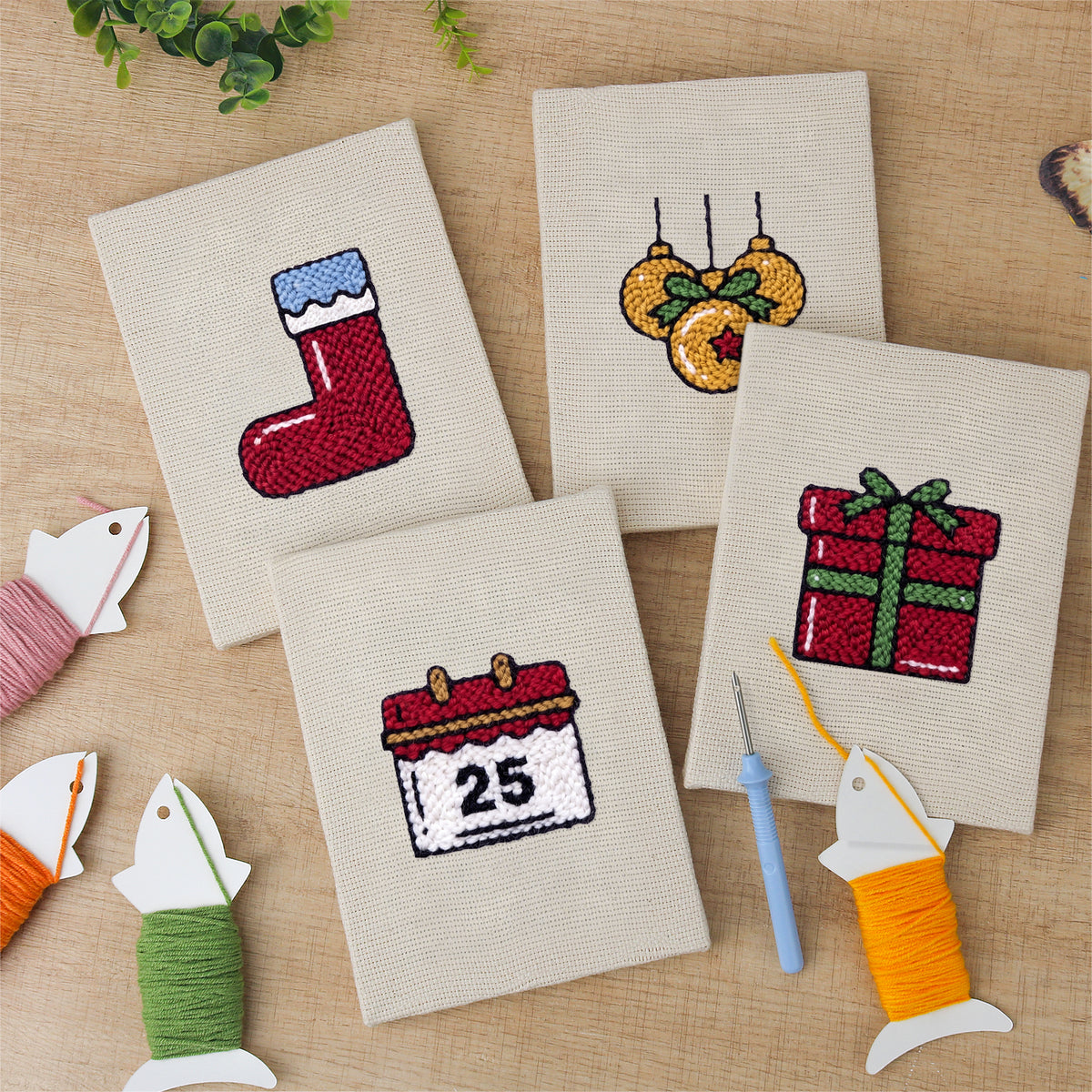 The four finished Christmas Morning mini canvases laid out on a table