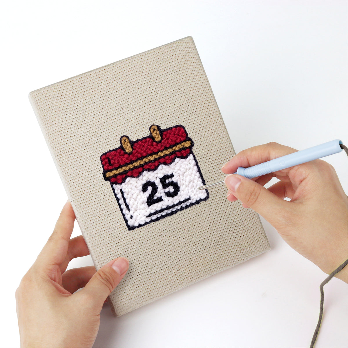 Punching a Christmas Morning mini canvas with the punch needle