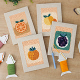 The four finished Citrus and Blackberries mini canvases laid out on a table